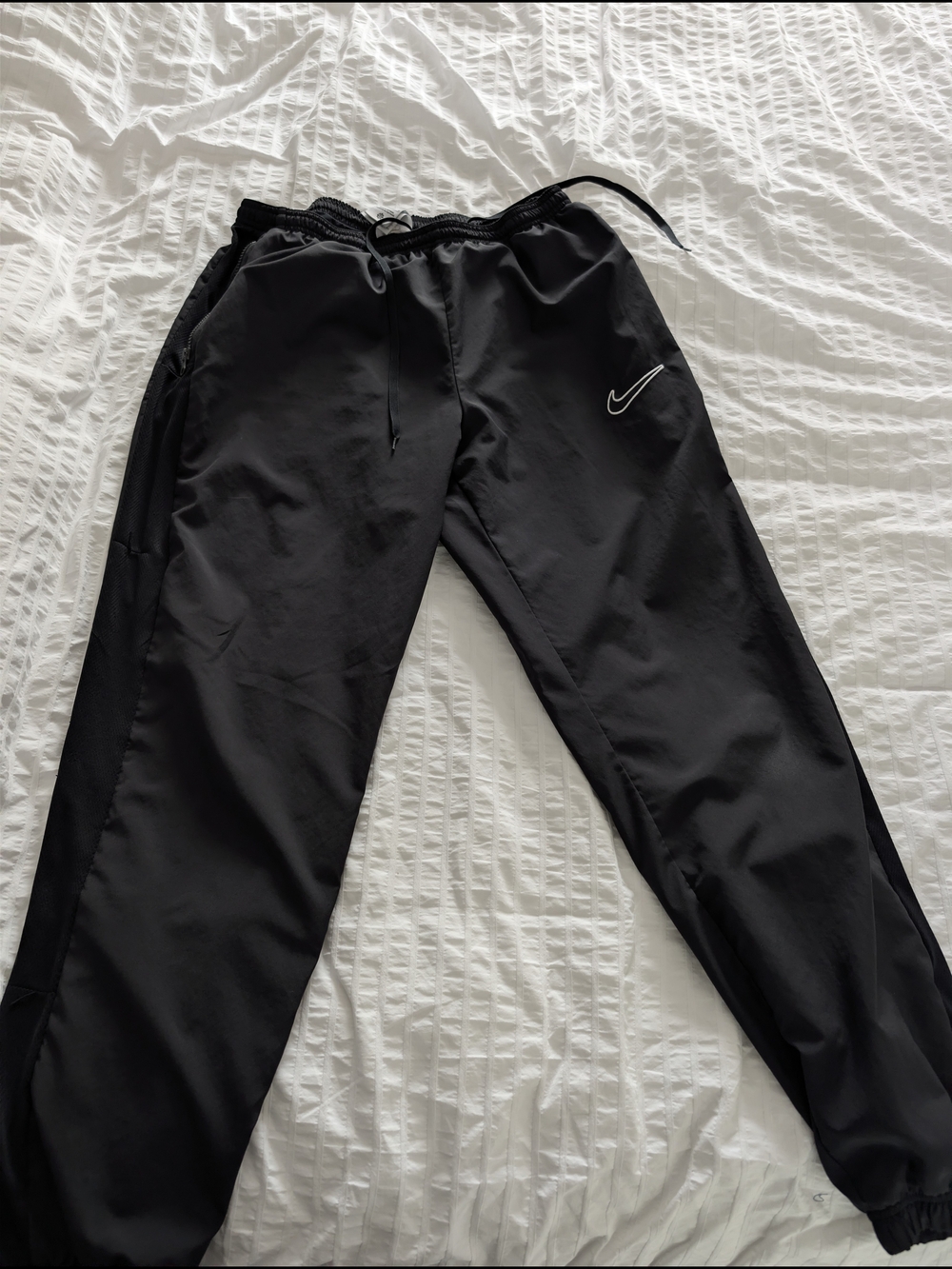 Nike Dri-FIT athletic track pants.